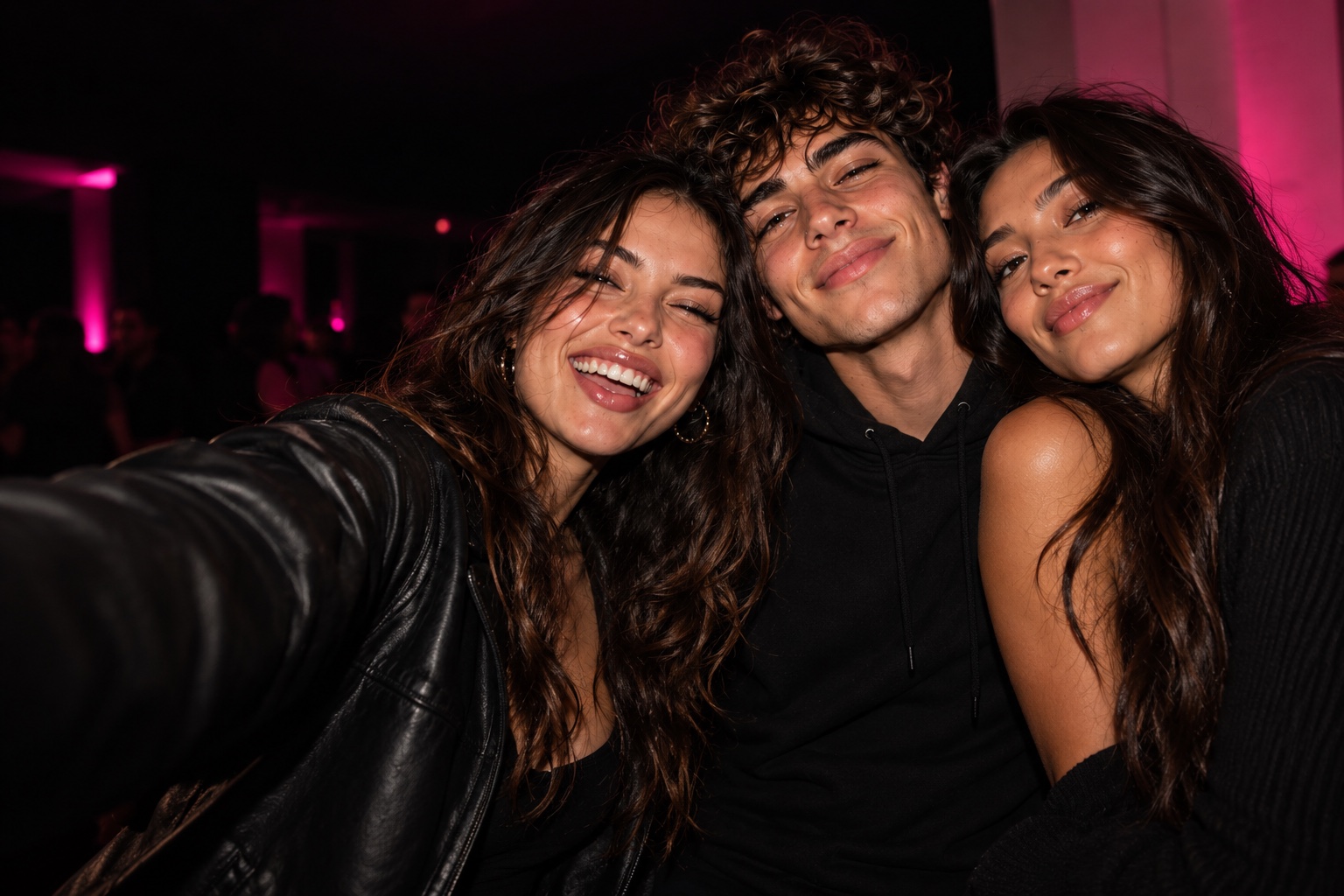 Three adult friends laughing together on a night out